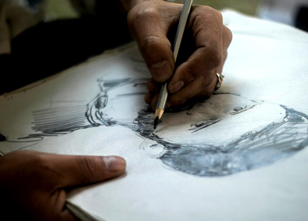 Portrait drawing workspace showing reference materials and sketching tools